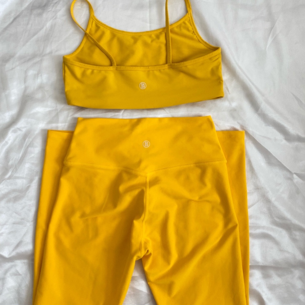 Bright yellow sports bra and matching leggings. Brand SAGE collective